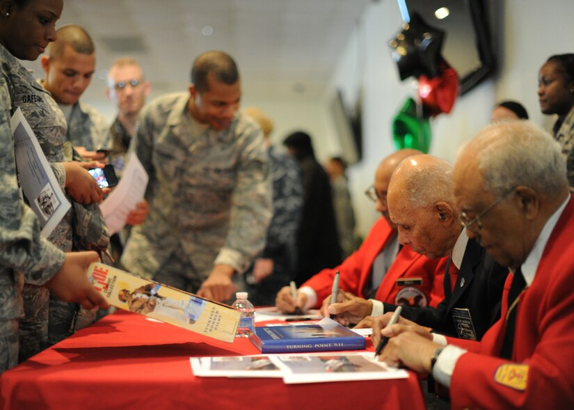 Tuskegee Airmen sign autographs for service members during the Black History Month Opening Breakfast at Joint Base Andrews, Md., Feb. 1, 2013. This free event kicked-off BHM and featured guest speaker Dr. Roscoe C. Brown Jr., who was a former Tuskegee Airman. (U.S. Air Force photo/ Staff Sgt. Nichelle Anderson) 