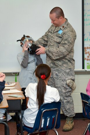 National Guard Major Doug Robertson makes a presentation during career day, February 01, 2013 at Dr. George Washington Carver Elementary School in Richmond Hill, Ga. Robertson demonstrated the procedure for donning a gas mask and answered questions from students in Mrs. Rachel Mahon's fifth grade class. (National Guard photo by Tech. Sgt. Charles Delano/released)
