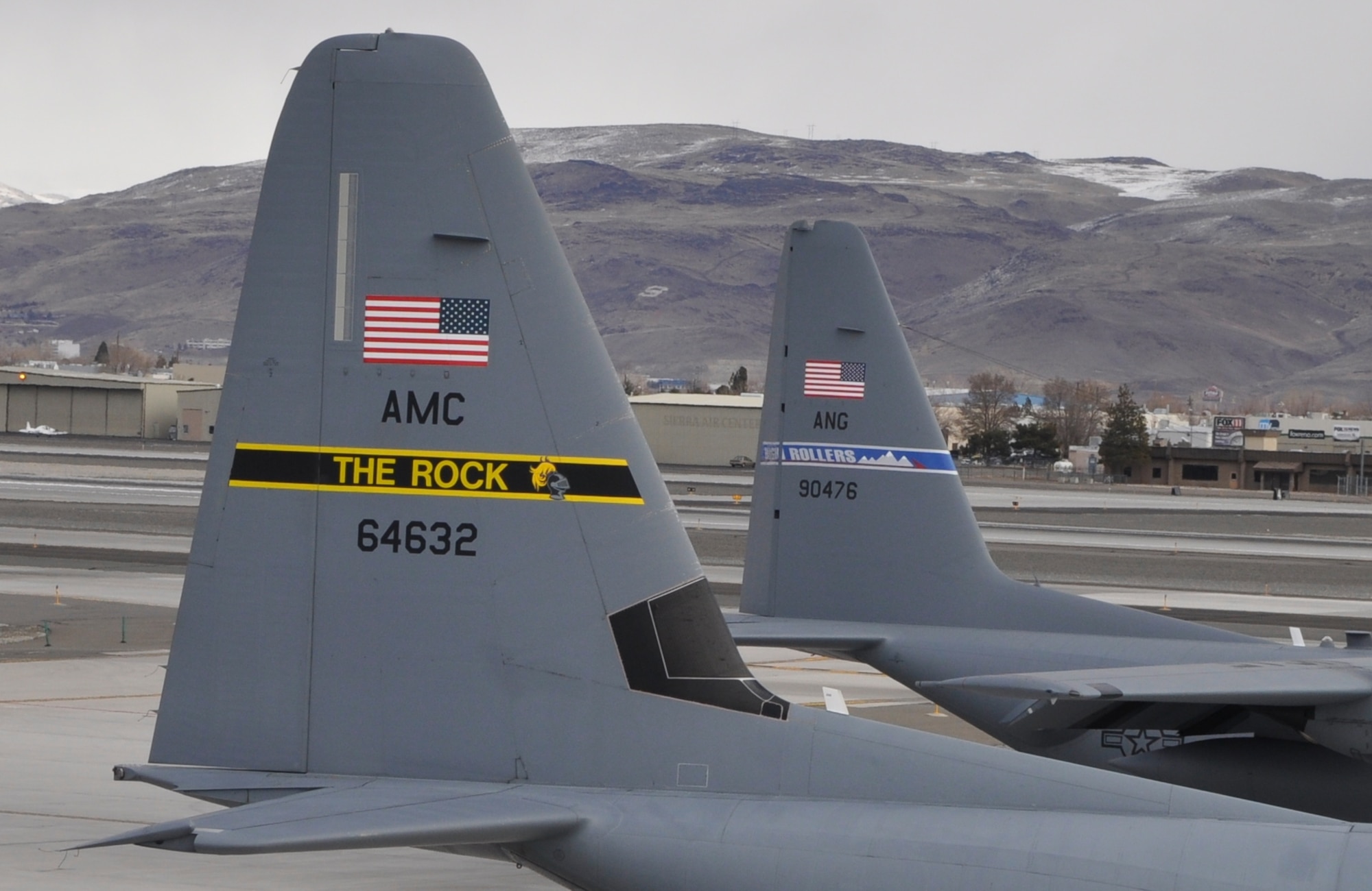 Tails of the 41st Airlift Squadron, Little Rock "The Rock" and 192nd Airlift Squadron "High Rollers" share the parking apron at the Nevada Air National Guard Base in Reno, Nev.  The 41st Airlift Squadron was in Reno to practice mountain flying and to conduct other training prior to deploying to Afghanistan (USAF photo by Capt. Jason Yuhasz released).
