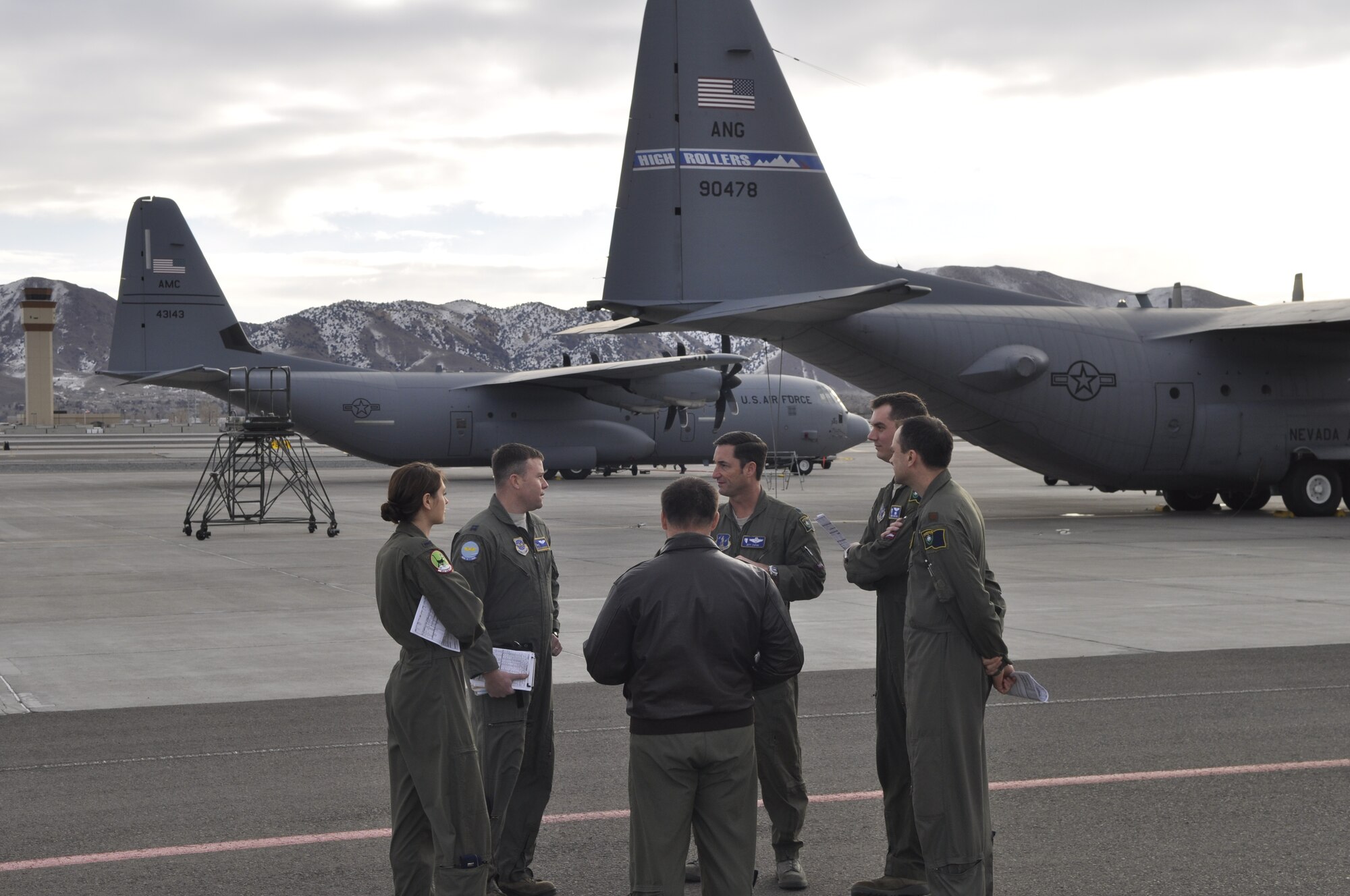 Lt. Col. Jeff Zupon (center, facing camera) and other members of the 192nd Airflift Squadron discuss interfly operations with members of the 41st Airlift Squardon prior to takeoff from the Nevada Air National Guard Base, Reno, Nev.  The 41st Airlift Squadron was in Reno to practice mountain flying and to conduct other training prior to deploying to Afghanistan.  (USAF photo by Capt. Jason Yuhasz released).
