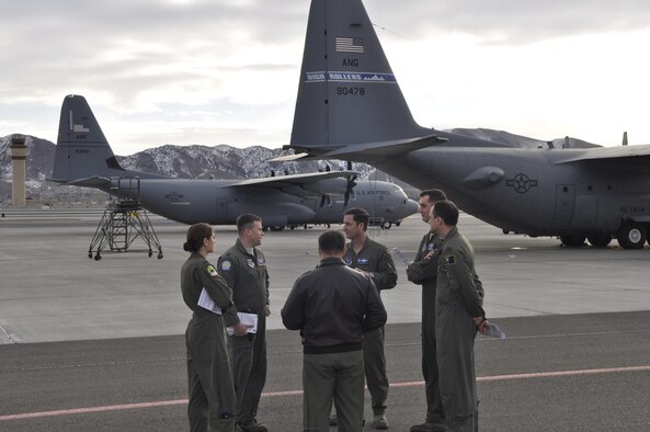 Lt. Col. Jeff Zupon (center, facing camera) and other members of the 192nd Airflift Squadron discuss interfly operations with members of the 41st Airlift Squardon prior to takeoff from the Nevada Air National Guard Base, Reno, Nev.  The 41st Airlift Squadron was in Reno to practice mountain flying and to conduct other training prior to deploying to Afghanistan.  (USAF photo by Capt. Jason Yuhasz released).
