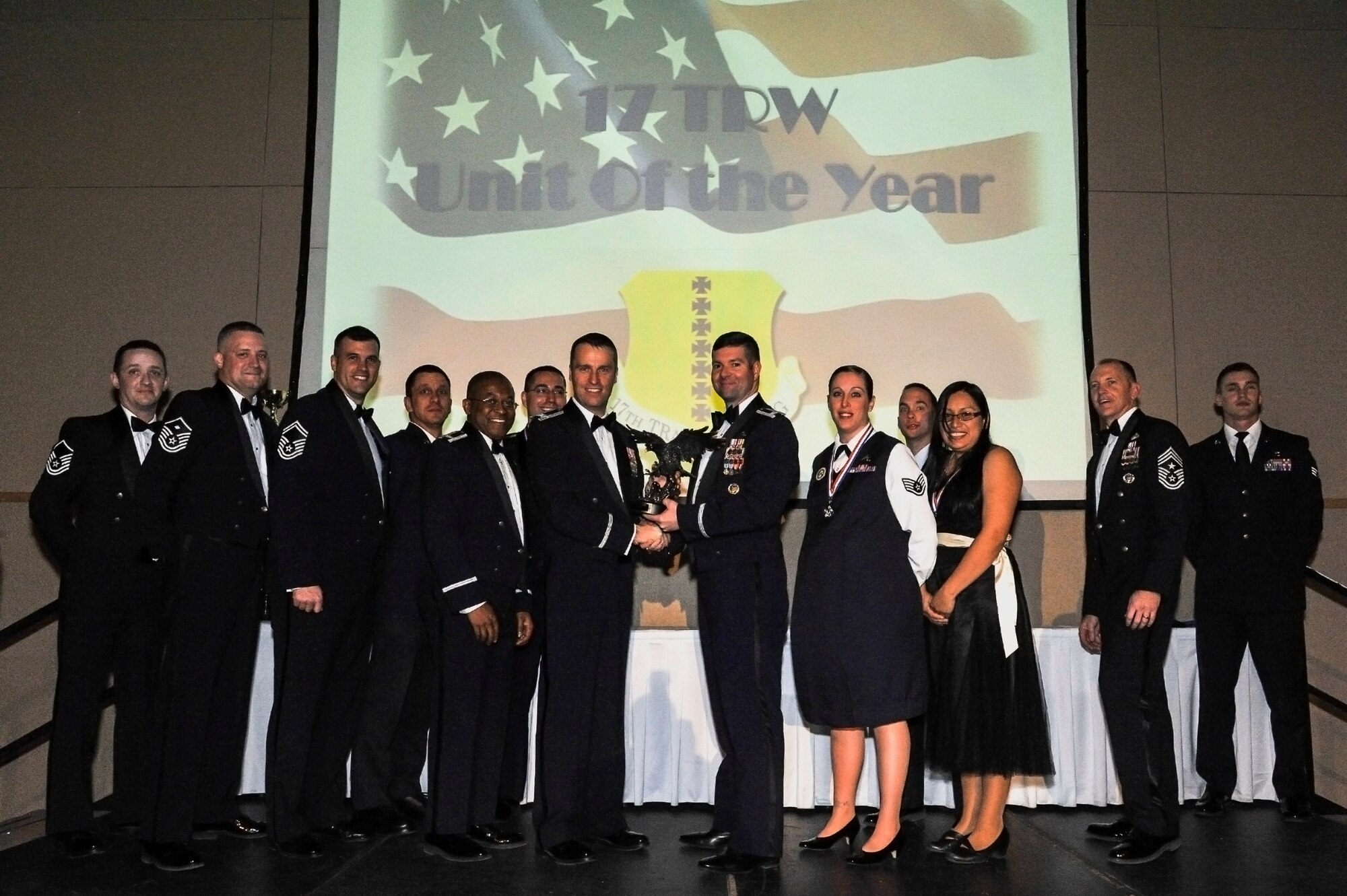 SAN ANGELO, Texas -- Lt. Col. Scott Nahrgang, 316th Training Squadron commander, and members from the 316th Training Squadron accepts the 17th Training Wing 2012 Unit of the Year on behalf of the 316th TRS from Col. Thomas Schmidt, 17th TRW vice commander, and Chief Master Sgt. Scott Lumpkin, 17th TRW Command Chief. The annual awards program recognizes military and civilian personnel who compete in 20 categories for their significant contributions to the 17th TRW, the community and the mission. (U.S. Air Force photo/Airman 1st Class Michael Smith)