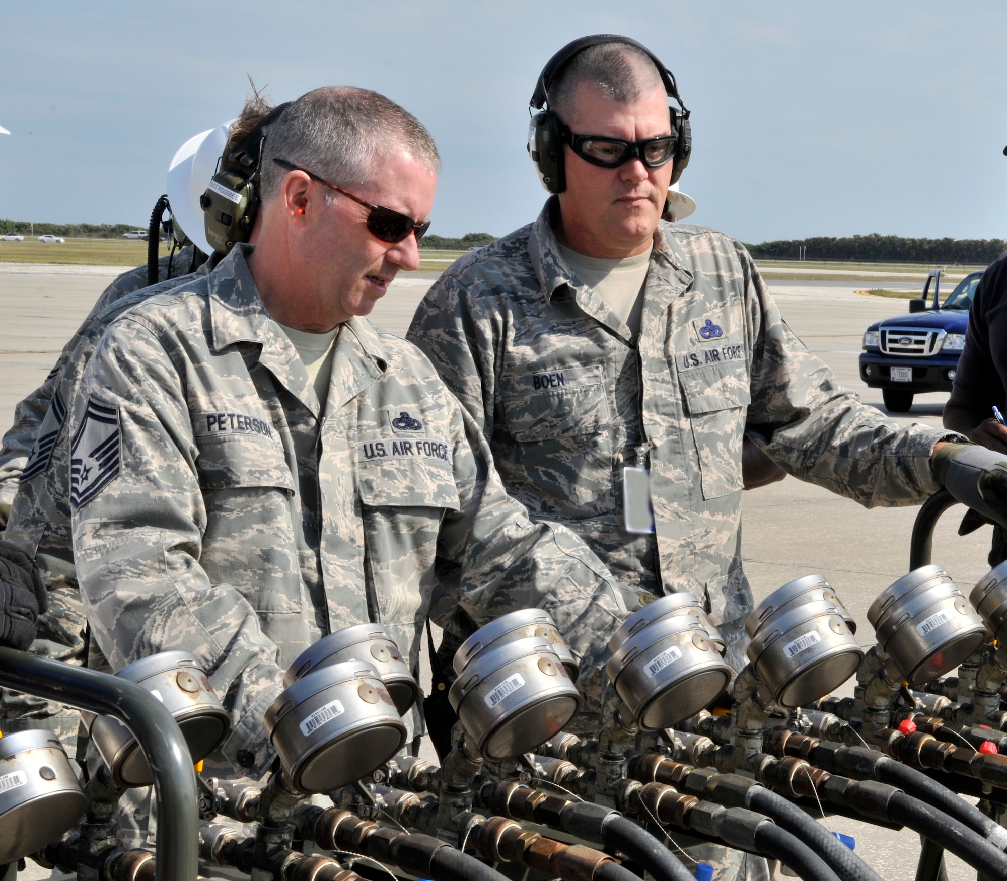 Senior Master Sgt. Dean Peterson on left and Master Sgt. Raymond Boen, both 920th Rescue Wing, Crash, Damage, Disabled Aircraft Recovery team members, monitor the gauges as the airbag positioned under a C-130 inflates.  The two along with other Patrick Air Force Base CDDAR members participated in a recent training exercise that simulated the collapse of the nose landing gear on a C-130. (U.S. Air Force photo/Tech. Sgt. Peter Dean)