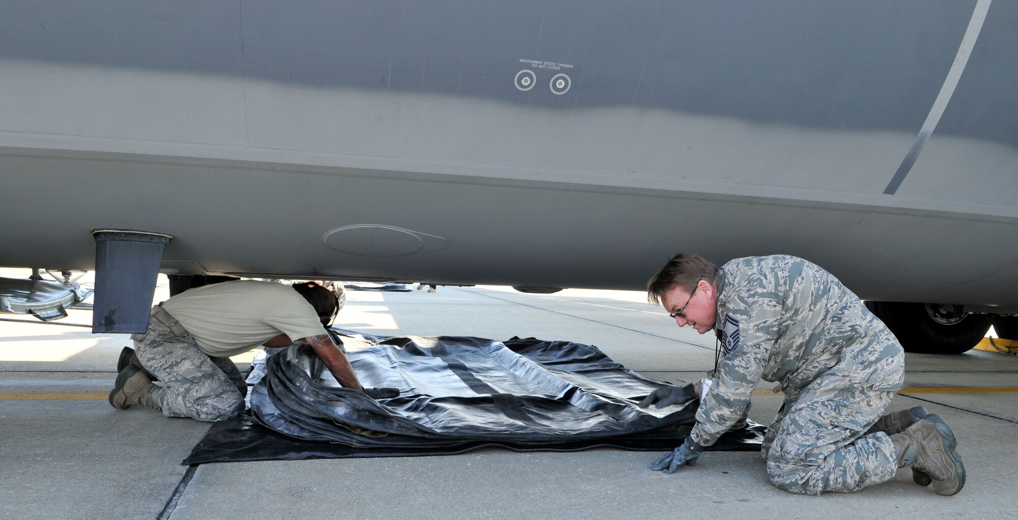 Air Force Reserve Command's 920th Rescue Wing and the active duty 45 Space Wing, Crash, Damage, Disabled Aircraft Recovery team members place an air bag under the belly of a C-130. The members were participating in a recent training exercise that simulated the collapse of the nose landing gear on a C-130. (U.S. Air Force photo/Tech. Sgt. Peter Dean)