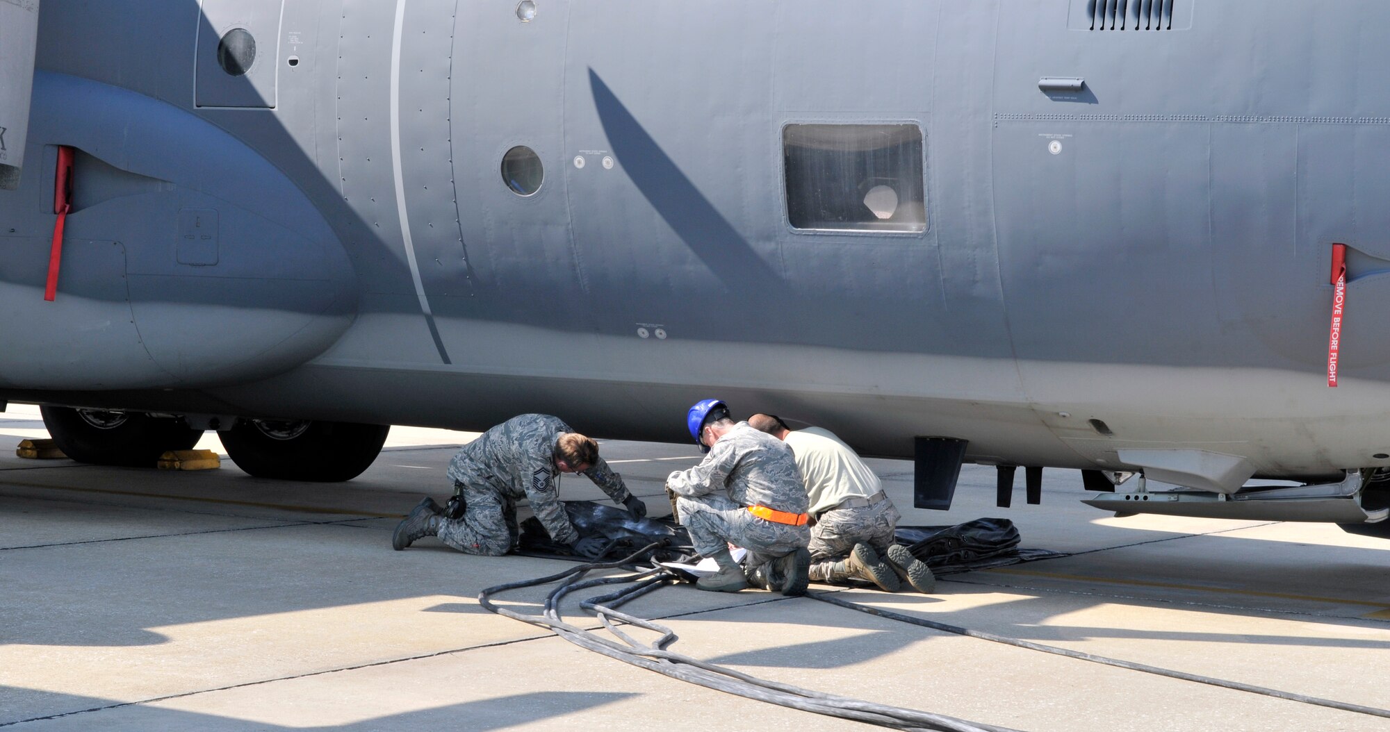Air Force Reserve Command's 920th Rescue Wing and the active duty 45 Space Wing, Crash, Damage, Disabled Aircraft Recovery team members place an air bag under the belly of a C-130. The members were participating in a recent training exercise that simulated the collapse of the nose landing gear on a C-130. (U.S. Air Force photo/Tech. Sgt. Peter Dean)
