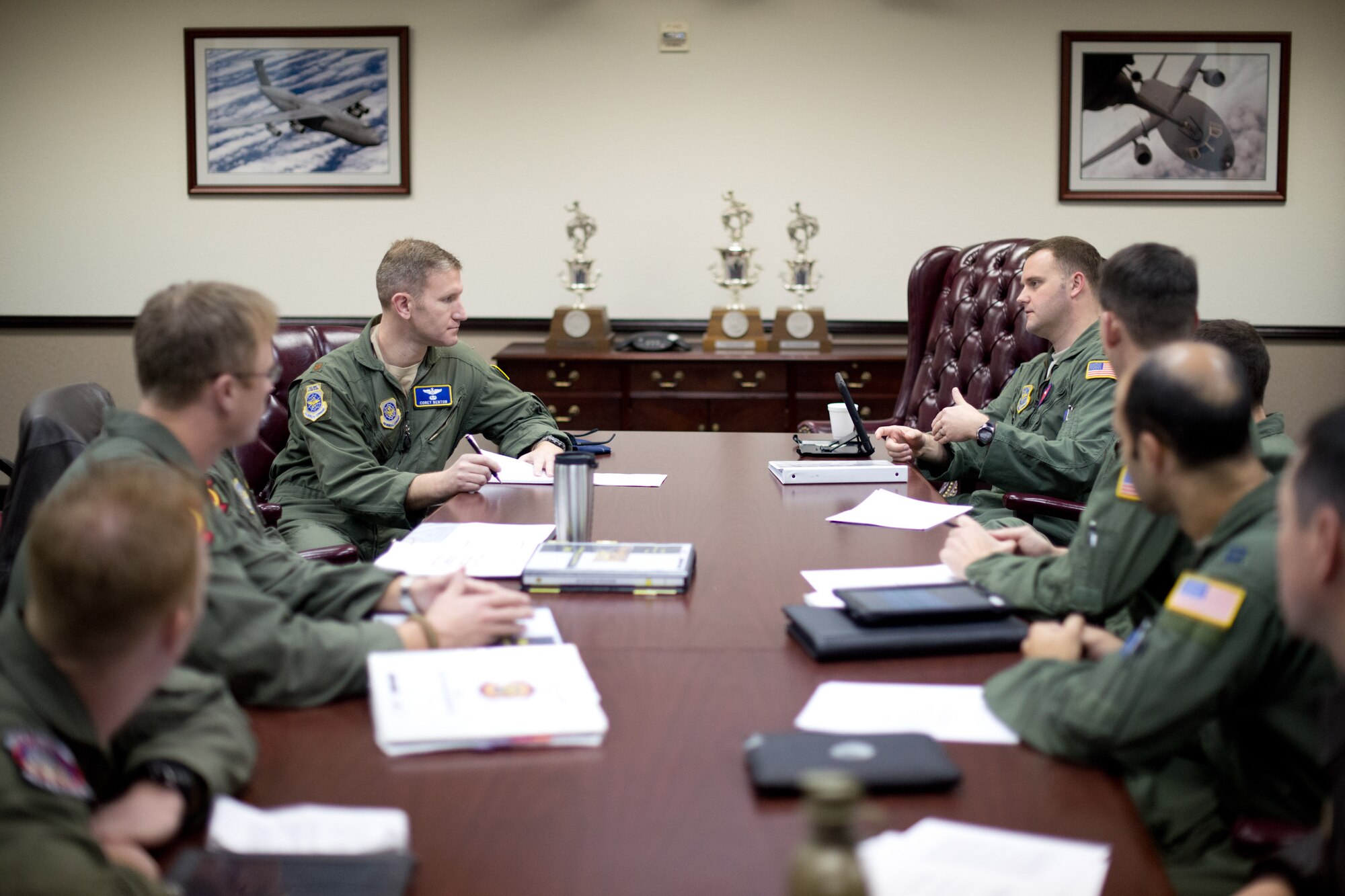 Maj. Corey Benton, Air Mobility Command's command evaluator for the KC-10 Extender aircraft interviews aircrew members from the 60th Operations Group about their standard evaluation procedures during this week's Aircrew Standardization and Evaluation Visit. The interview is part of a two phase inspection that also includes observing Airmen on the job and ensuring their compliance with Air Force instructions. (U.S. Air Force Photo/Ken Wright)