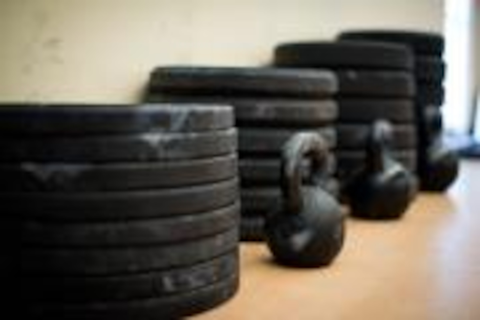 Stacks of rubber weights and a few kettlebells await a morning WOD at the Raptor Cage. (Courtesy photo)