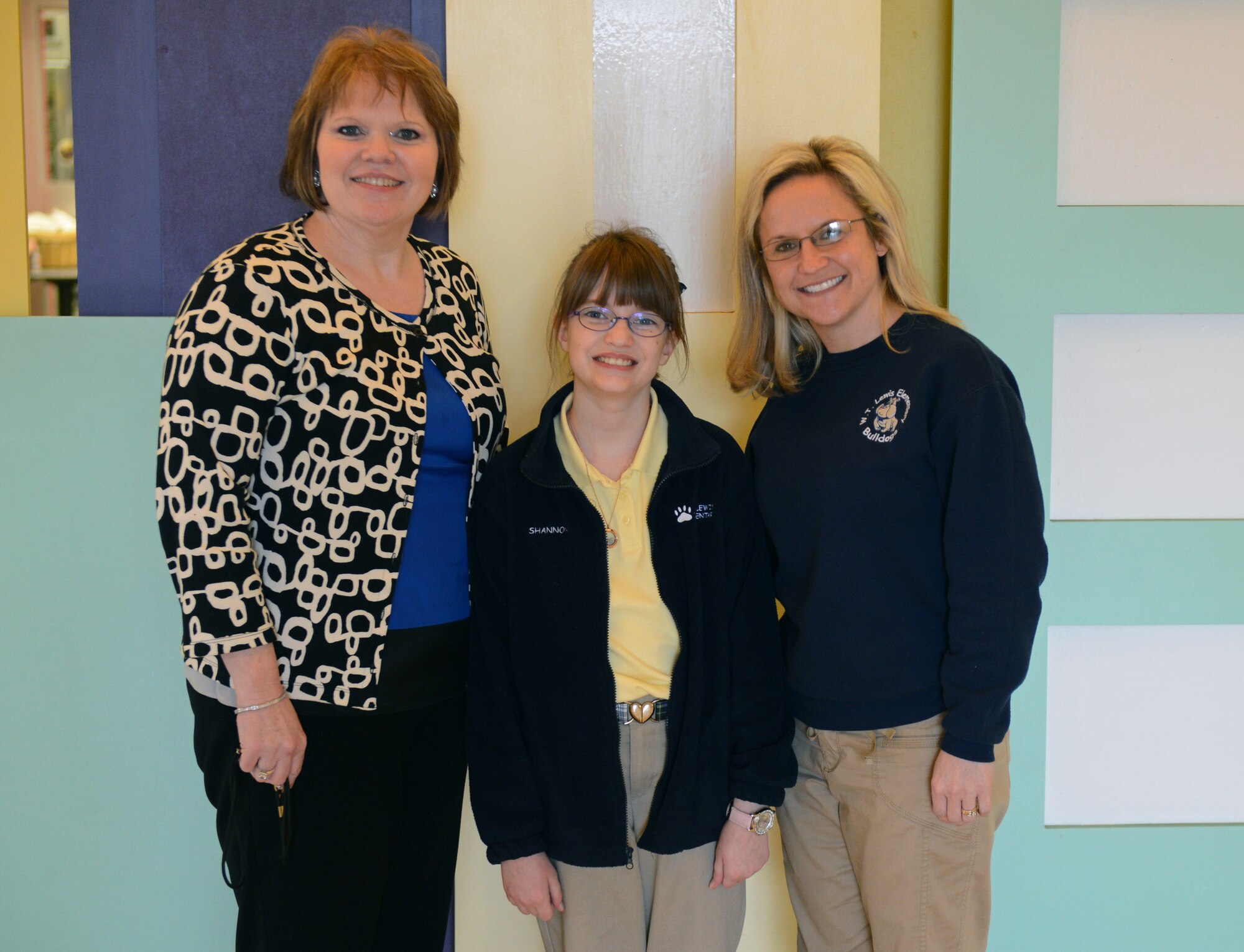 Janiene Batchelor, W.T. Lewis Elementary school principal, Shannon Mathers, W.T. Lewis fifth grader and daughter of Jeanie and Col. Russell Mathers, 8th Air Force chief of staff, and Kim Hawn, fifth grade teacher, pose for a photo at W.T. Lewis Elementary school in Bossier City, La., Jan. 30. Shannon was nominated as Bossier Parish's Elementary Student of the Year and will go on to compete for the regional title March 5. (U.S. Air Force photo/Senior Airman Micaiah Anthony) 
