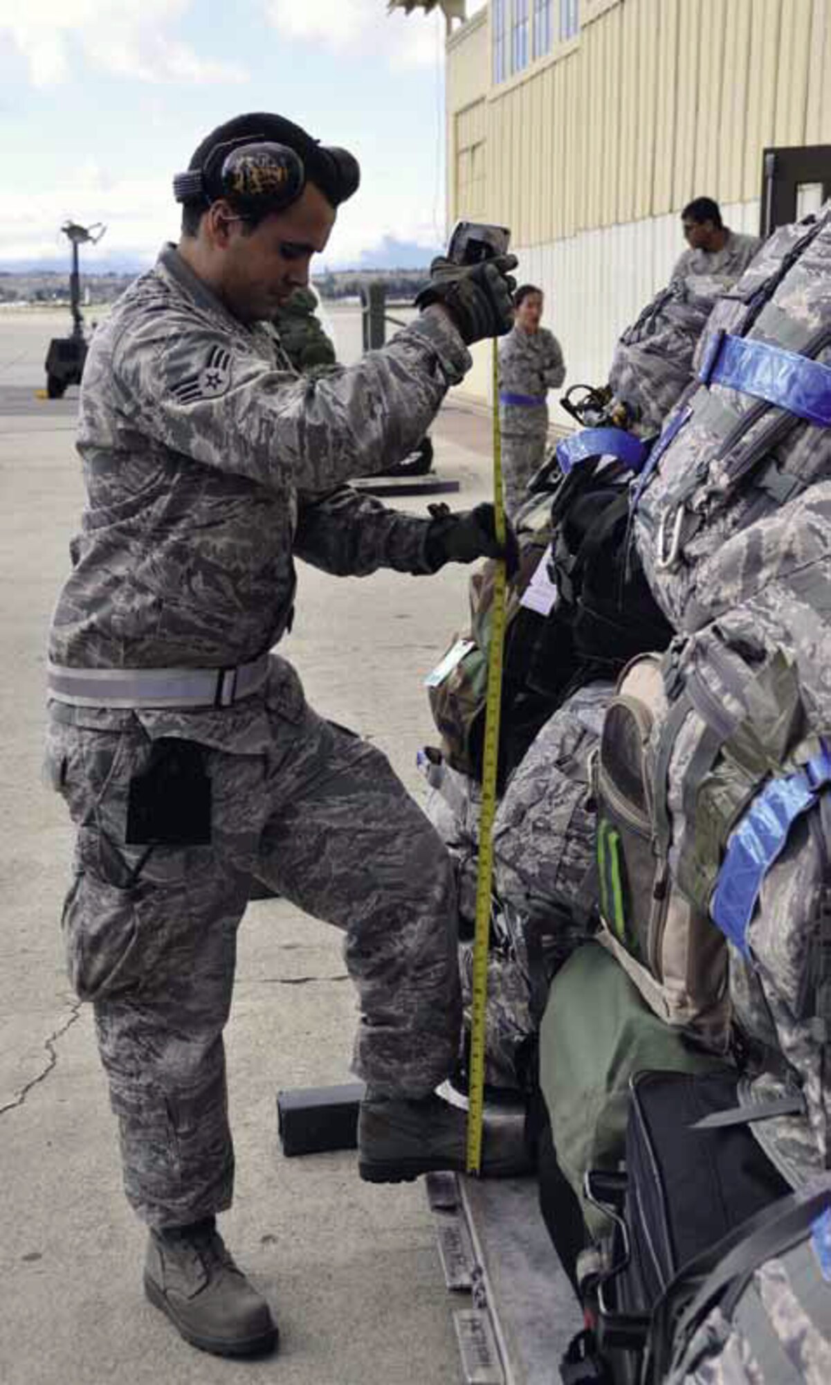 Senior Airman Andrew Conde, 50th Aerial Port Squadron, skillfully measures the height of baggage on a pallet to ensure it meets load requirements for a C-17 bound for Gulfport, Miss., in support of the ORI. (U.S. Air Force photo by Master Sgt. Linda Welz)