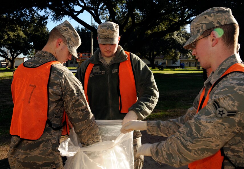 Airmen assigned to bay orderly duty gather trash for disposal on Barksdale Air Force Base, La., Jan. 31. Bay orderlies are picked from a pool of volunteers from the various units on Barksdale from a rotating schedule. Duties include custodial maintenance, cleaning unused rooms and preparing rooms for inbound Airmen. (U.S. Air Force photo/Airman 1st Class Andrew Moua)
