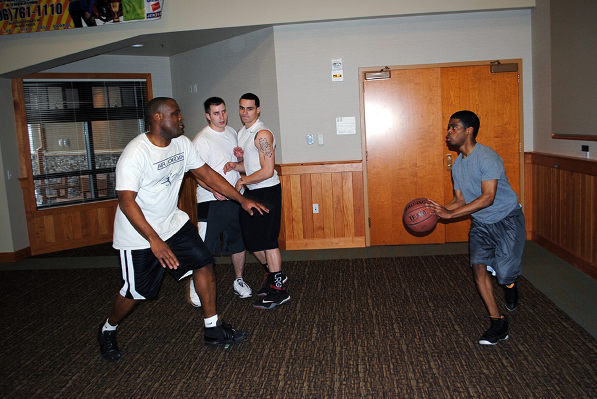 Senior Airman Phillip Winder (right), 341st Security Forces Squadron member, faces off against Staff Sgt. Gerald Garrow (left), 341st Missile Security Forces Squadron member, during a 2-on-2 basketball game at the Wing Sports Smackdown on Jan. 25 at the Grizzly Bend. Several prizes were awarded to the day’s individual and team winners including exercise equipment, a Great Falls Shooting Complex one-year membership, a backpack and an abdominal lounger. (U.S. Air Force photo/Senior Airman Cortney Paxton)