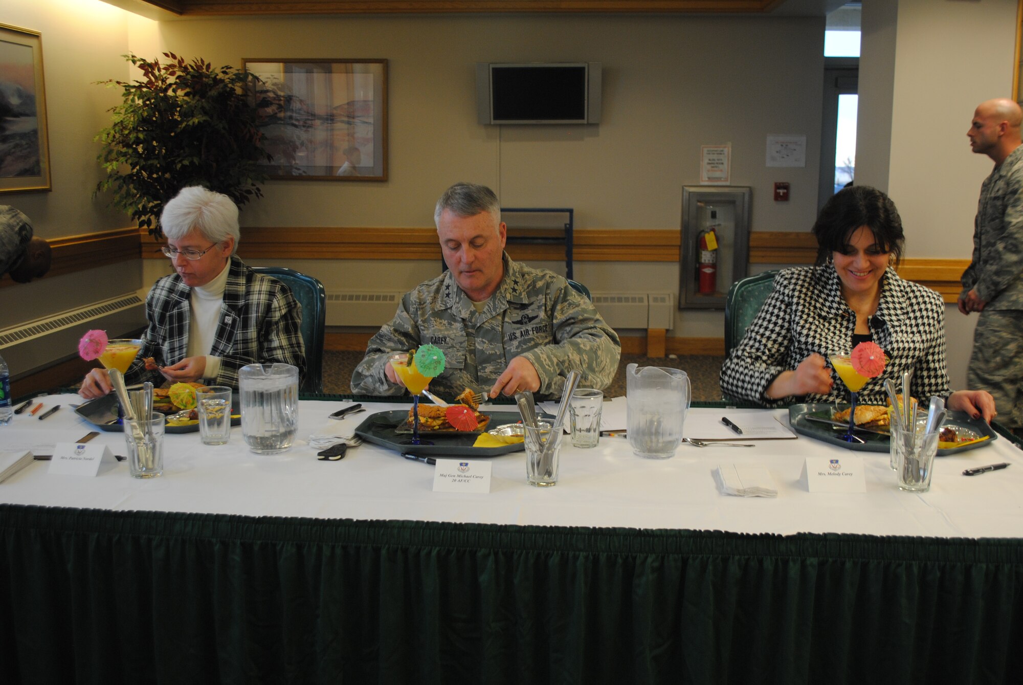 Judges Patricia Nordel, left, Maj. Gen. Michael Carey, 20th Air Force commander, and his wife Melody dig into the entrée prepared by the 819th RED HORSE Squadron team, Staff Sgts. Jennierfer Barnaby and Stephen Marvin. Every entrée was judged on taste, texture, appearance/presentation, honoring theme ingredient and dress and appearance. (U.S. Air force photo/Airman 1st Class Katrina Heikkinen)