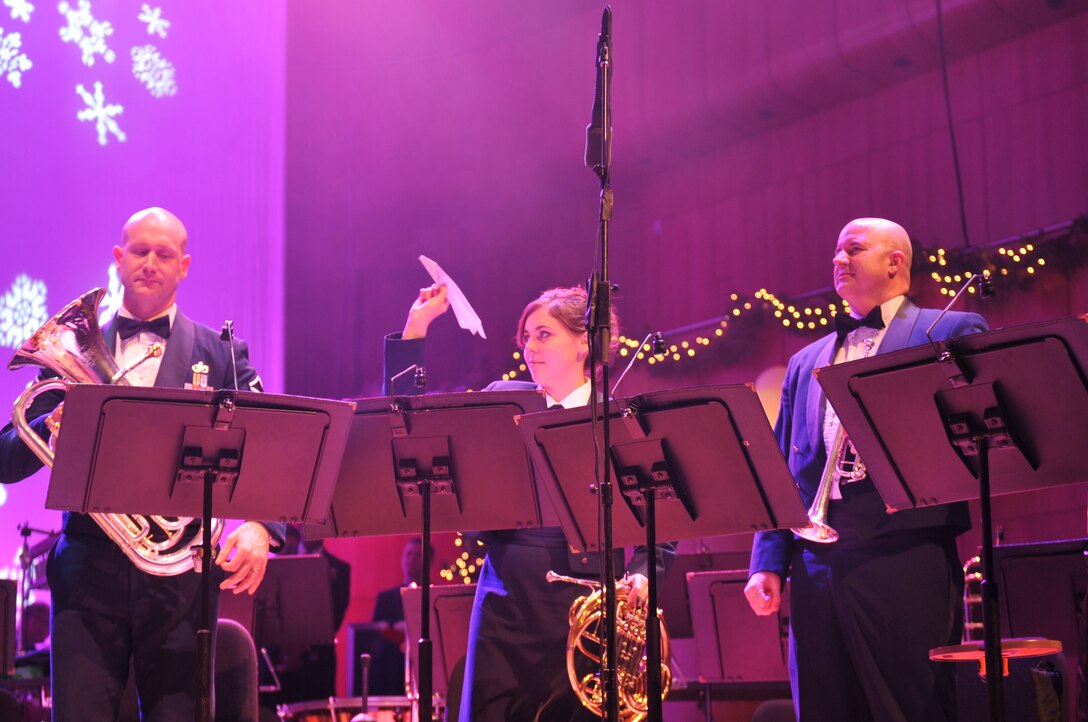 Airman First Class Alena Zidlicky aims a paper airplane at a 'rival' during "Overture Battle Royal from 'The Nutcracker'" with Heartland Brass and Offutt Brass 