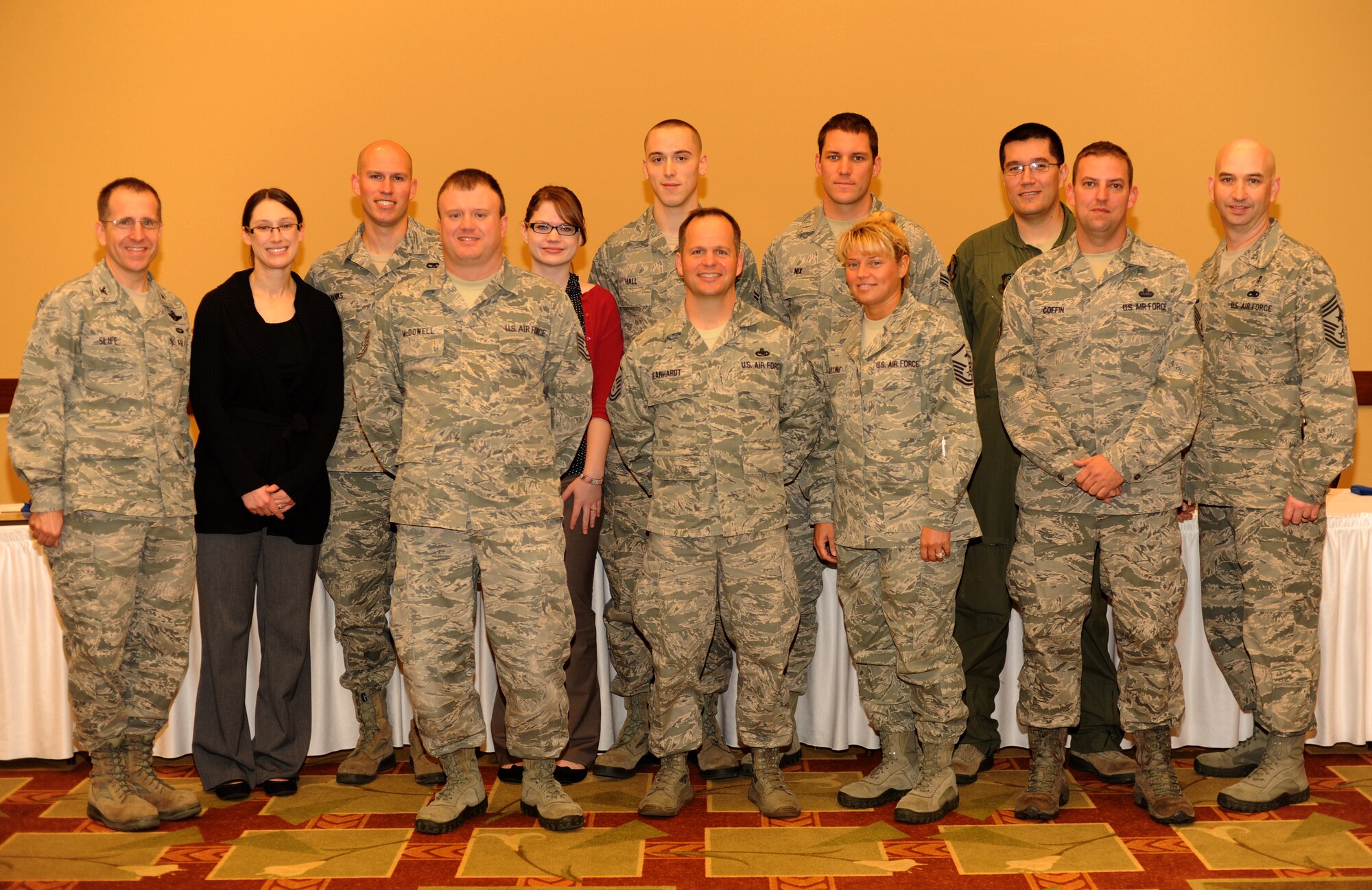 (From left to right) Col. Jim Slife, commander of 1st Special Operations Wing, Joanne Banks, Airman 1st Class Seth Banks, 1st Special Operations Logistics Readiness Squadron, Tech. Sgt. Michael McDowell, additional duty first sergeant of 801st Special Operations Aircraft Maintenance Squadron, Katie Hall, Airman 1st Class William Hall, 801st SOAMXS, Master Sgt. Phillip Gearhardt, first sergeant of 1st SOLRS, Senior Airman Timothy Nix, 10th Combat Weather Squadron, Master Sgt. Kristina Mullins, first sergeant of 10th CWS, Senior Airman Thomas Coyle, 25th Intelligence Squadron, Master Sgt. Grange Coffin, first sergeant of 25th IS, and Chief Master Sgt. Jeffrey Maberry, command chief of 1st SOW, pose after the Diamond Sharp presentation at the Soundside Club at Hurlburt Field, Fla., Feb. 1, 2013.  The Hurlburt First Sergeants' Council selects Airmen for the "Diamond Sharp" recognition for exceptional performance. (U.S. Air Force photo / Senior Airman Joe McFadden)