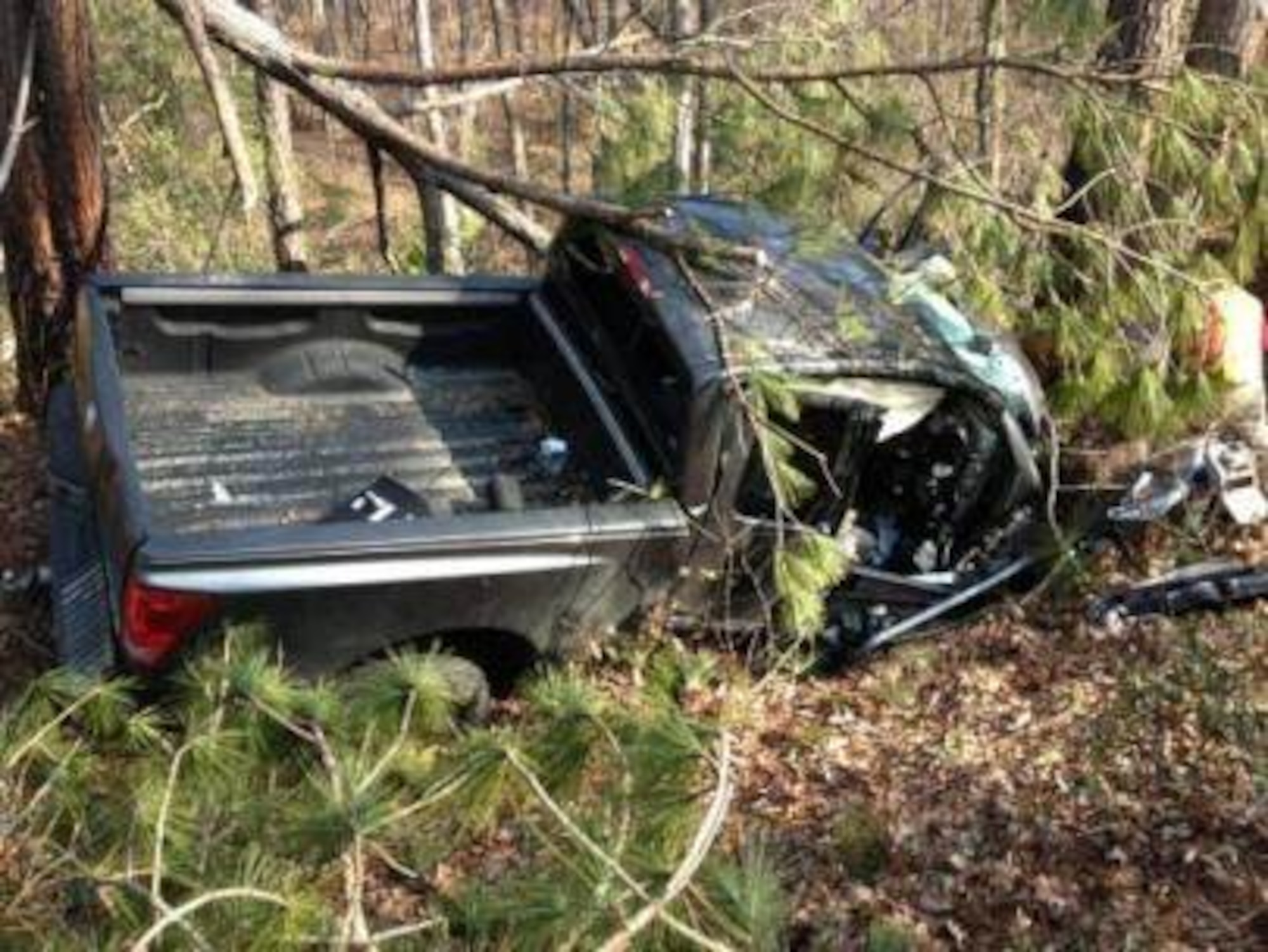 Maj. Francis Damon Friedman, the director of operations at the 21st Special Tactics Squadron, Pope Field, N.C., smashed the cab window to gain access to the driver of this Toyota Tundra Jan. 29, 2013 who veered off the road into a tree-lined ditch. Friedman was the first responder on scene, applying First Aid and remaining in the truck with the victim until medics could extricate her from the vehicle. (Courtesy photo)  