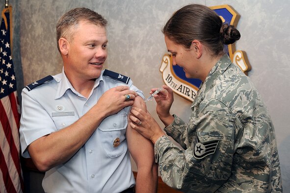 Staff Sgt. Melissa Baxter administers a flu shot to 10th Air Base Wing Commander Col. Tim Gibson Sept. 4, 2012. Flu shots at the Academy's Allergy and Immunizations Clinic are limited to cadets and active-duty service members assigned to the Academy. Baxter is an immunization technician with the 10th Aerospace Medicine Squadron. (U.S. Air Force photo/Elizabeth Andrews)