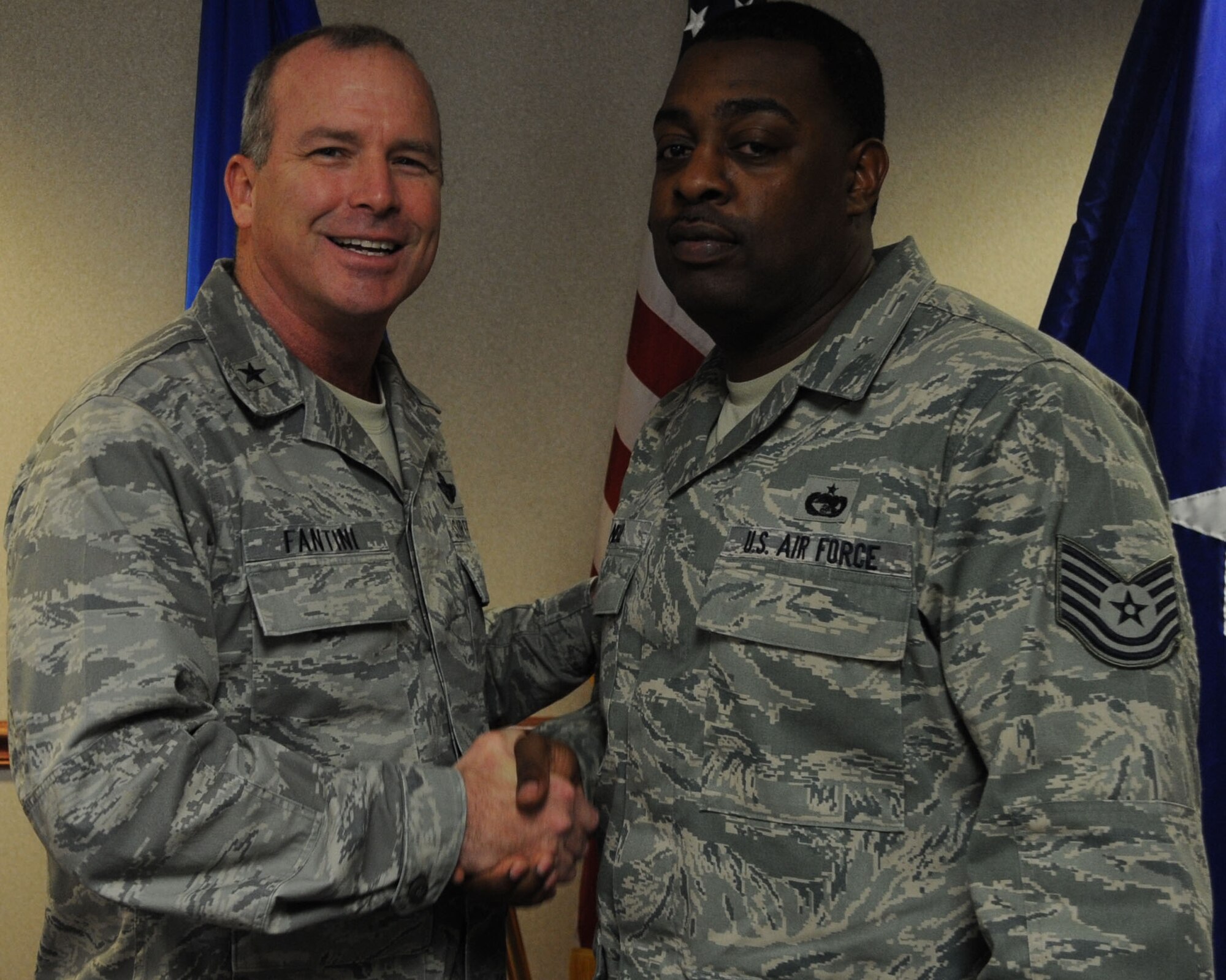 Brig. Gen. Michael Fantini, commander of the 82nd Training Wing, congratulates Tech. Sgt. Brian Neal of the 82nd Logistics Readiness Squadron Jan. 30, 2013, in the wing conference room at Sheppard Air Force Base. Neal received the AETC Traffic Management NCO of the Year award.