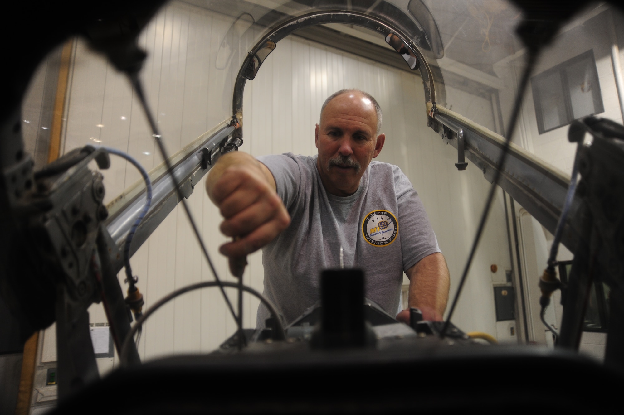WHITEMAN AIR FORCE BASE, Mo. -- Russ Cass, M1 Support services aircraft mechanic, checks the tightness of a screw on an ejection seat in a T-38 Talon, Jan. 24. The ejection seat is rocket-powered to allow pilots to escape aircraft in case of an emergency. (U.S. Air Force photo/Staff Sgt. Nick Wilson) (Released)