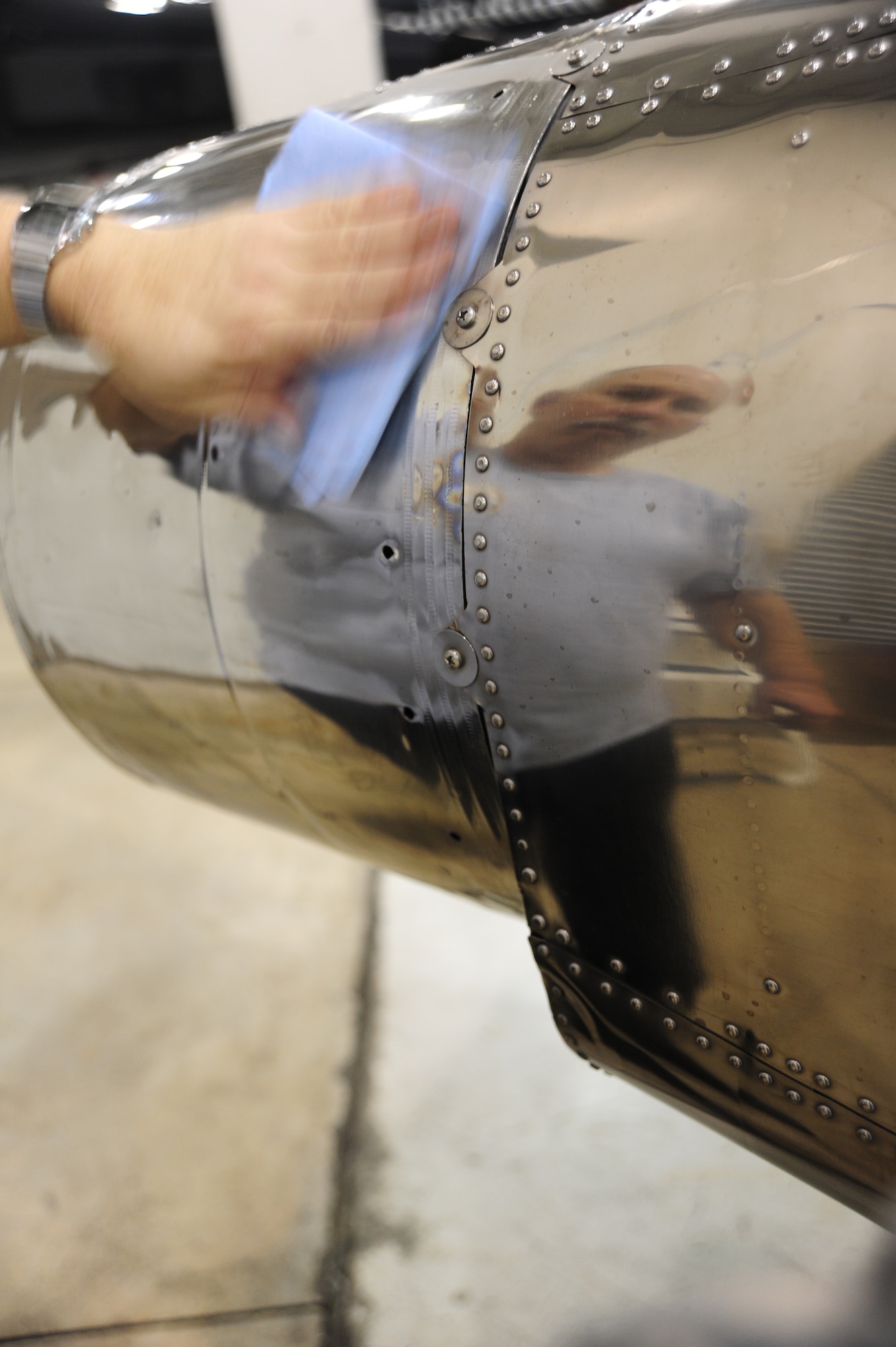 WHITEMAN AIR FORCE BASE, Mo. -- Russ Cass, M1 Support services aircraft mechanic, cleans the exhaust pipes of a T-38 Talon, Jan. 25. When the aircraft is cleaned it makes it easier for mechanics to spot defects on the airframe, according to Cass. (U.S. Air Force photo/Staff Sgt. Nick Wilson) (Released)