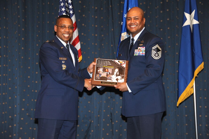 Col. Clarence “CJ” Johnson, commander of the Air Force Nuclear Weapons Center’s Nuclear Capabilities Directorate, left, receives a commemorative plaque from Senior Master Sgt. Gregory Smith, superintendent of the Kirtland AFB Command Post and chairman of the base’s Dr. Martin Luther King Jr. Day Committee. Johnson was the guest speaker Jan. 25 during Kirtland AFB’s Martin Luther King Jr. Day Luncheon at the Mountain View Club. 
