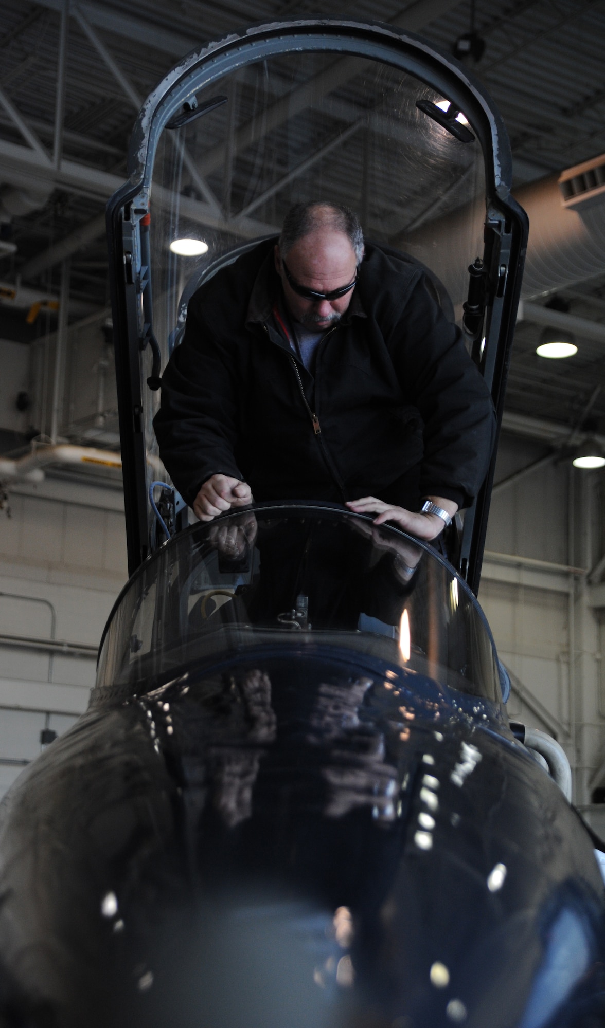 WHITEMAN AIR FORCE BASE, Mo. -- Russ Cass, M1 Support services aircraft mechanic, performs a post-flight inspection on a T-38 Talon, Jan. 23. The post-flight inspection helps aircraft mechanics find malfunctions in various aircraft components that might have occurred during flight. (U.S. Air Force photo/Staff Sgt. Nick Wilson) (Released)