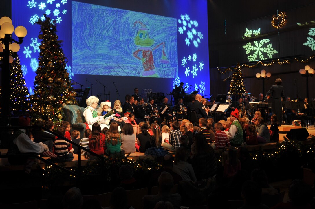 Mrs. Clause tells children the story of "How the Grinch Stole Christmas!" while the Concert Band provides the score accompanied by images drawn by local students.