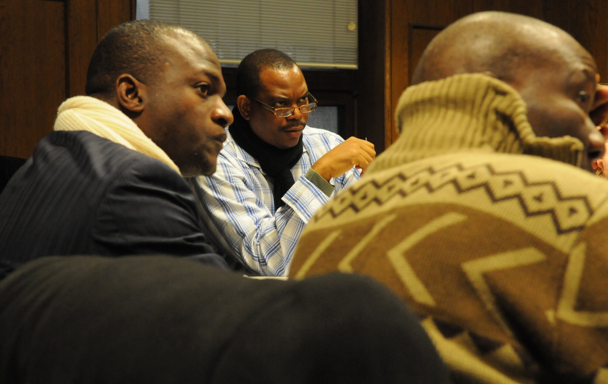 RAMSTEIN AIR BASE, Germany -- Adedayo Makun, Deputy Director, Directorate of Defense Information, Goodwill Industries, Defense Headquarters Abuja, Nigeria, (Center) and Chukwuma O. Agbanusi, senior editor for Radio Nigeria (Left), listen to a briefing about U.S. Air Forces Africa during a visit to Headquarters U.S. AFAFRICA Public Affairs here Jan. 30. The visit was part of U.S. Africa Command's Media Visit Program.  U.S. Air Force Photo by Tech. Sgt. James M. Hodgman