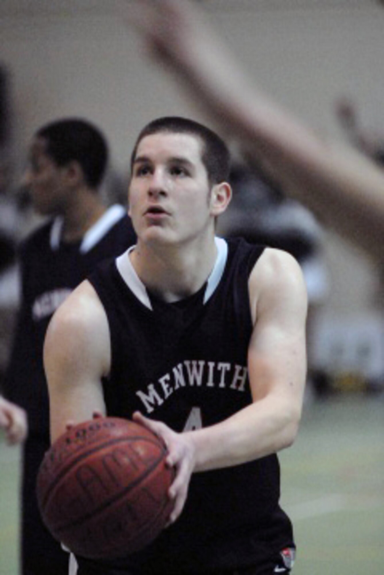 RAF ALCONBURY, United Kingdom – Schuyler Backlar, a senior for Menwith Hill, eyes the basket from the free throw line during the Mustangs' win against Rota Friday during the Division III winter basketball tournament at RAF Alconbury, United Kingdom. (Photo by Jennifer H. Svan/Stars and Stripes)