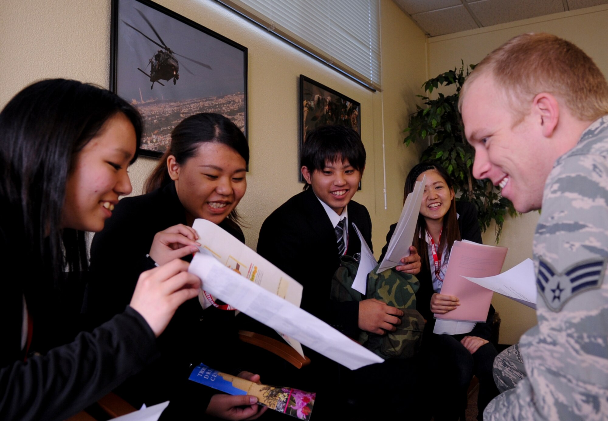 U.S. Air Force Senior Airman Nicholas Dodds, 18th Medical Group biomedical equipment technician, visits with students from the Nikkei College of Business in Okinawa City on Kadena Air Base, Japan, Jan. 30, 2013. The program supports the local community by interacting with students to help improve their English skills. It also offers an opportunity for Air Force members to interact with the students and show what their jobs are. (U.S. Air Force photo/Naoto Anazawa)