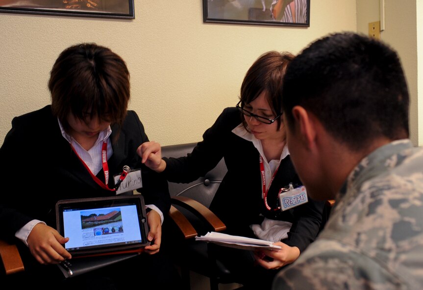 U.S. Air Force Senior Airman Christopher Almaraz, 18th Civil Engineer Group structural journeyman, interacts with students from the Nikkei College of Business in Okinawa City on Kadena Air Base, Japan, Jan. 30, 2013. During their tour, the students shared the history and culture of Okinawa with the Airmen. (U.S. Air Force photo/Naoto Anazawa)