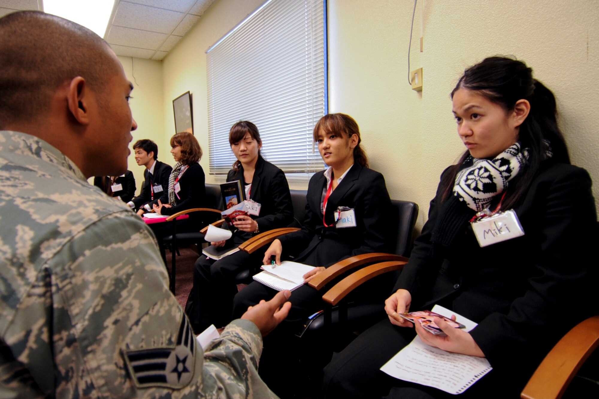 U.S. Air Force Senior Airman Jon-Mark Quibar, 18th Civil Engineer Group structural journeyman, visits with students from the Nikkei College of Business in Okinawa City on Kadena Air Base, Japan, Jan. 30, 2013. The program supports the local community by interacting with students to help improve their English skills. It also offers an opportunity for Air Force members to interact with the students and show what the Air Force mission. (U.S. Air Force photo/Naoto Anazawa)