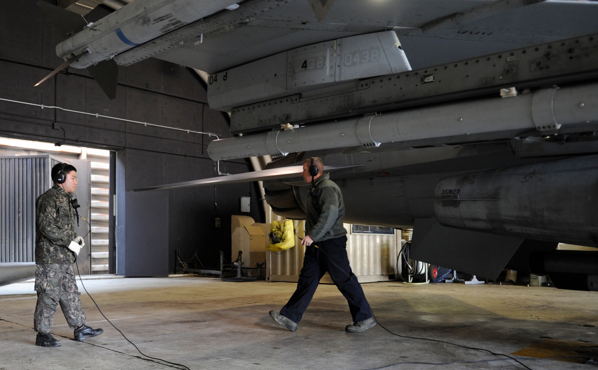 Republic of Korea Air Force Master Sgt. Teun Teun Jung, left, observes how Senior Airman Cody Fouratt, 8th Aircraft Maintenance Squadron, launches an F-16 Fighting Falcon Jan. 30, 2012, at Kunsan Air Base, Republic of Korea. Talking to each other helped the airmen understand differences in operating and gain an appreciation for what the other deals with. (U.S. Air Force photo by Senior Airman Brigitte N. Brantley/Released)