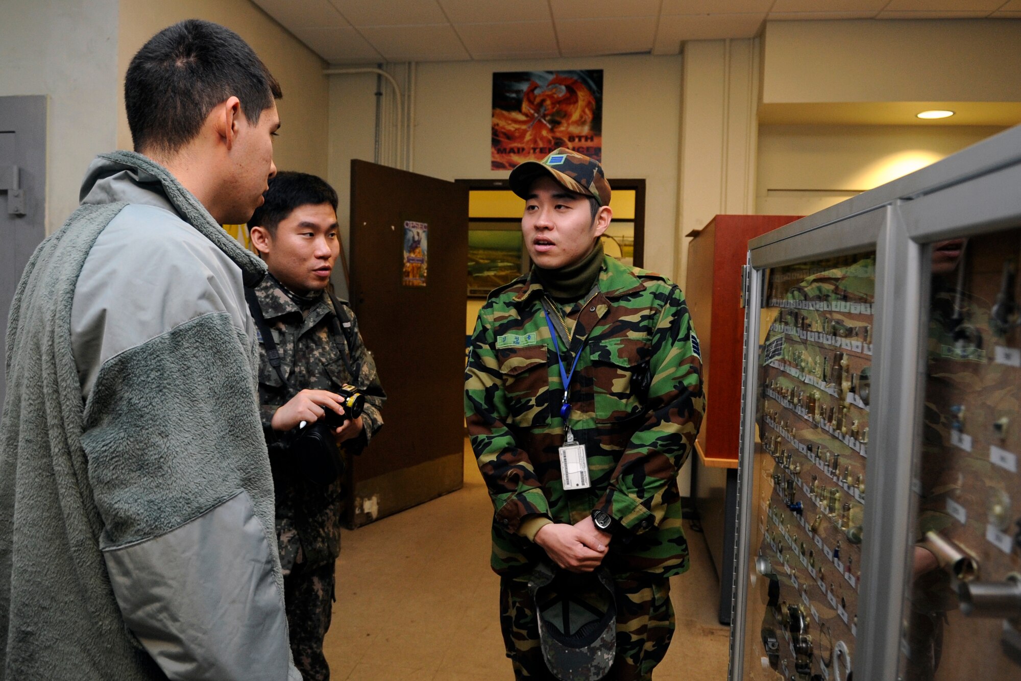 Republic of Korea Air Force Staff Sgt. Jeong Yong Kim, right, translates for Senior Airman Javier Zepeda, 35th Aircraft Maintenance, and ROKAF Master Sgt. Teun Teun Jung, during a career exchange day, Jan. 30, 2012, at Kunsan Air Base, Republic of Korea. Jung complimented many of the Air Force’s processes, including one where maintainers match up the part they need to one on a display board. (U.S. Air Force photo by Senior Airman Brigitte N. Brantley/Released)