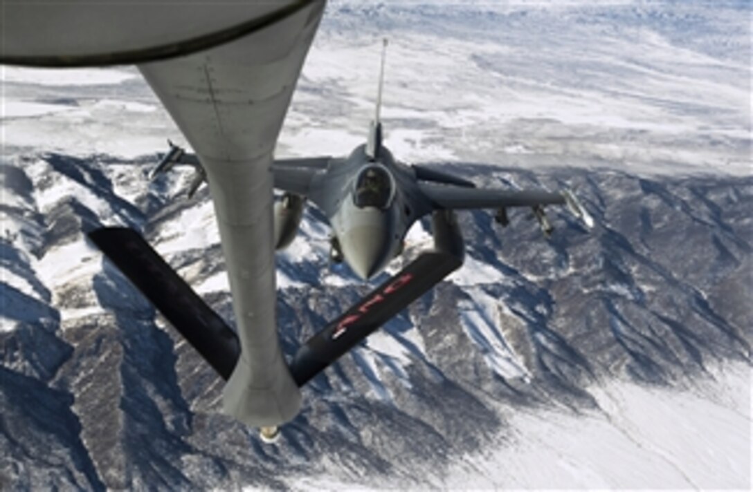 A U.S. Air Force pilot maneuvers his F-16CG Fighting Falcon into position behind the refueling boom of a KC-135 Stratotanker to receive fuel during a training mission over Utah on Jan. 18, 2013.  The Fighting Falcon is attached to the 421st Fighter Squadron, Hill Air Force Base, Utah.  The Stratotanker is attached to the 151st Air Refueling Wing of the Utah Air National Guard.  