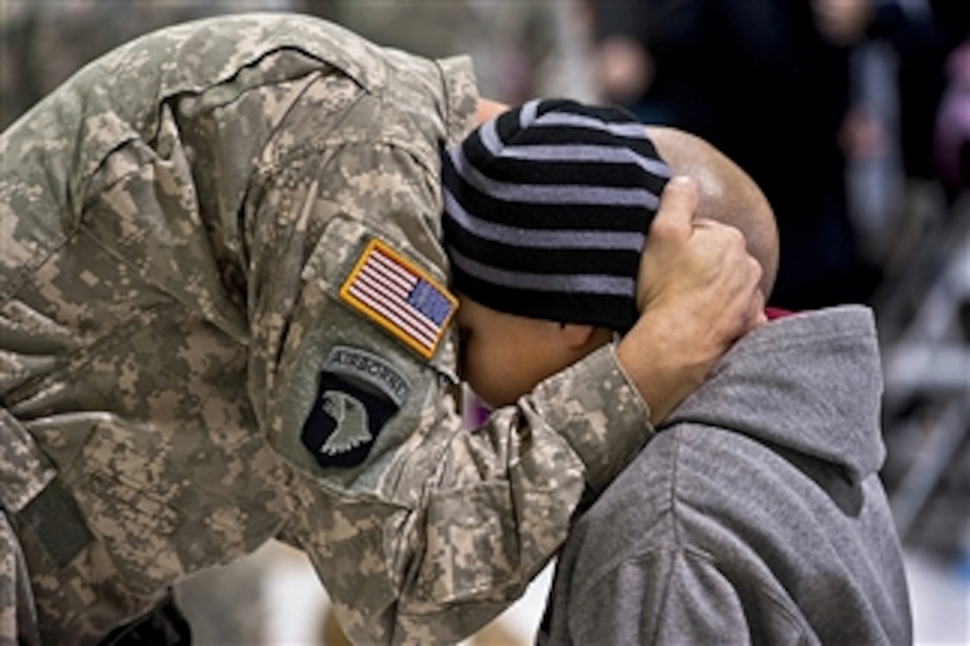 A soldier shares a hug and says his goodbye during a farewell ceremony at McEntire Joint National Guard Base, S.C., on Jan. 26, 2013.  The soldier, assigned to the South Carolina Army National Guard, will head to Fort Hood, Texas, to train before deploying to Afghanistan.  