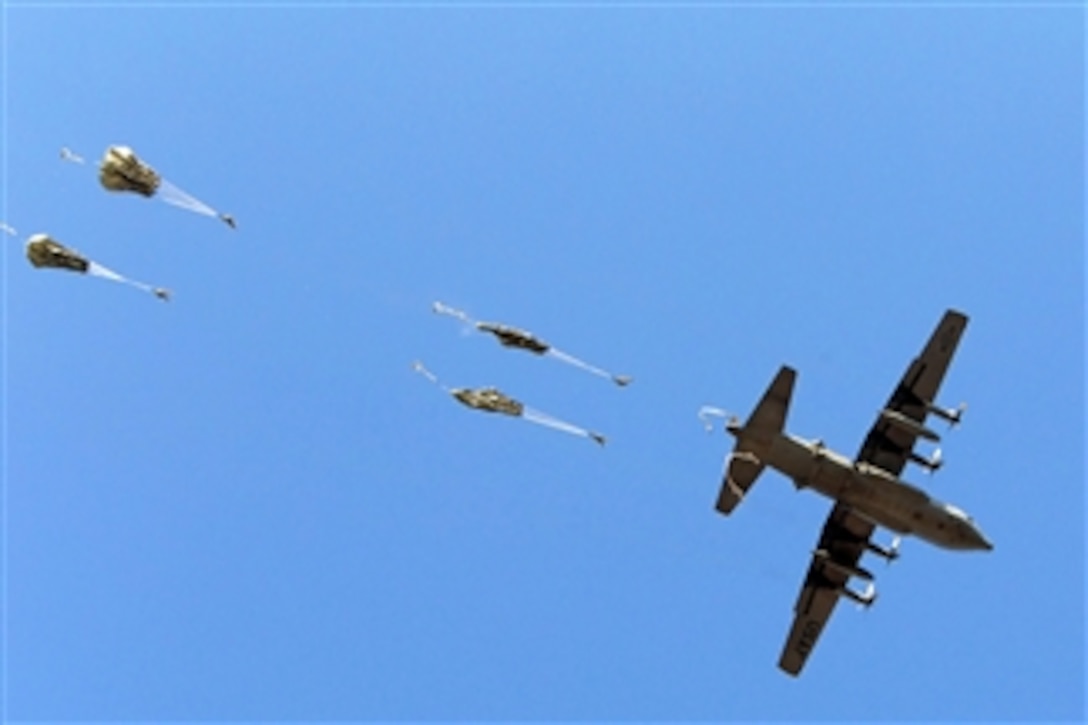 U.S. Army paratroopers with the 82nd Airborne Division’s 1st Brigade Combat Team exit a C-130 Hercules during an airborne training operation at Fort Bragg, N.C., on Jan. 29, 2013.  The paratroopers are using the Army’s newest parachute system, the T-11 Non-Steerable Troop Parachute System, which was designed to carry a heavier load, prevent oscillations, and reduce injuries to paratroopers upon landing.   