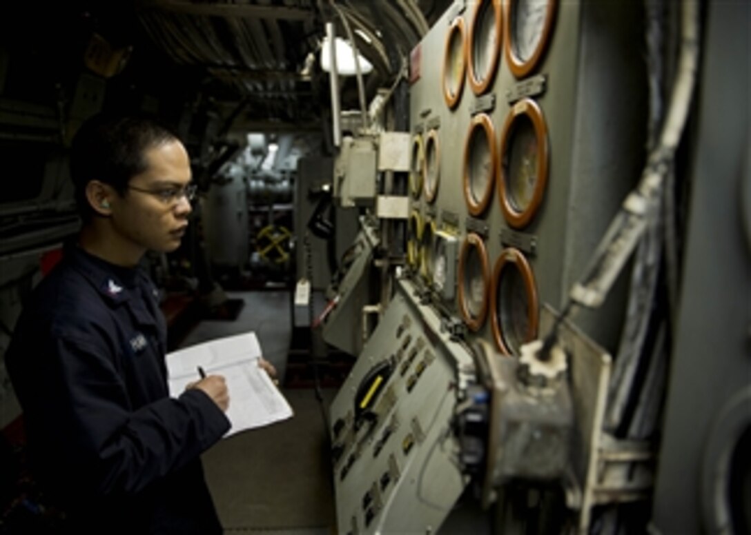 U.S. Navy Petty Officer 3rd Class Kaung Han logs meter readings while standing equipment monitor watch in the Main Engineering Room 2 of the amphibious dock landing ship USS Tortuga (LSD 46) as the ship steams in the East China Sea on Jan. 30, 2013.  The Tortuga is part of the Bonhomme Richard Amphibious Ready Group and is operating in the U.S. 7th Fleet area of responsibility.  