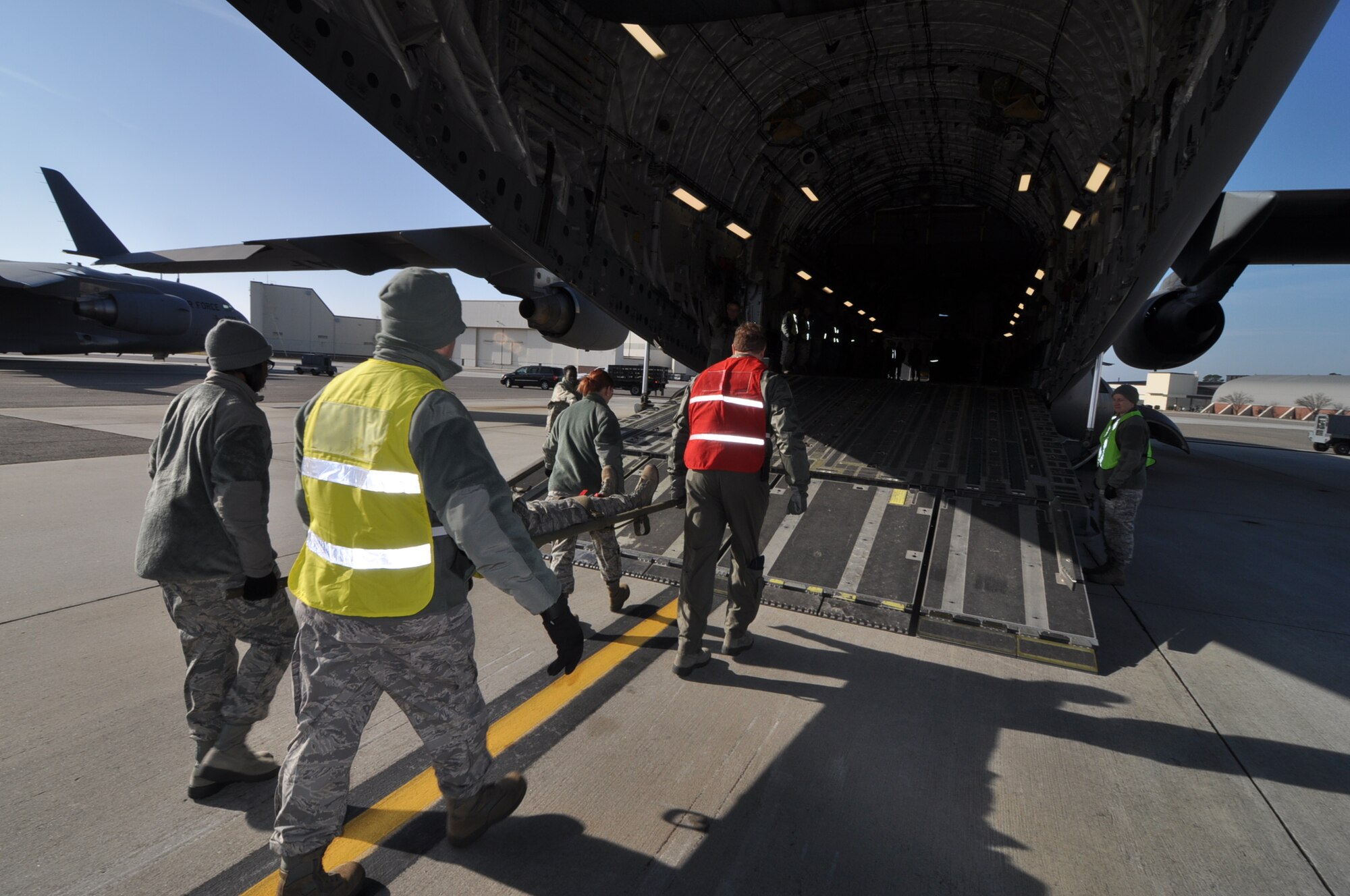 An injured Airman is being transported onto a C-17 Globemaster III Jan. 28, 2012 at Joint Base Charleston, S.C. The 315th Aerospace Medicine Squadron conducted a mass casualty exercise, and more than 145 Airmen from the 315th Airlift Wing participated in the event. Firefighters, civil engineers, members of the clinic, and aeromedical evacuation personnel all played crucial roles in the success of the exercise. (U.S. Air Force photo/Staff Sgt. Shane Ellis)