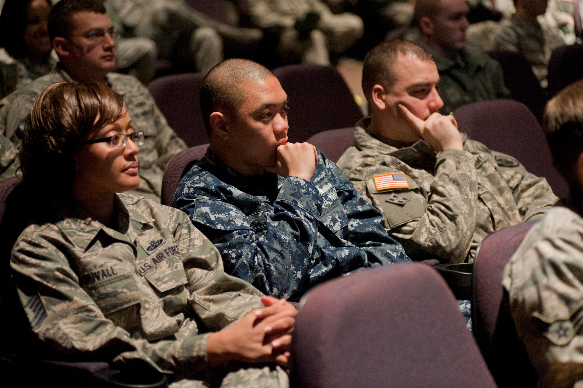 JOINT BASE ELMENDORF-RICHARDSON, Alaska -- An Airman, a Sailor and a Soldier listen during an all call with the Senior Enlisted Advisor to the Chairman of the Joint Chiefs of Staff, Marine Sgt. Maj. Bryan Battaglia, during his visit to JBER Feb. 1. The sergeant major toured the installation and provided insight on the bigger military picture. Battaglia became SEAC Oct. 1, 2011 and is the second to serve in the position. The SEAC is a military position within the U.S. Department of Defense and is designated the senior NCO in the United States armed forces, appointed by the Chairman of the Joint Chiefs of Staff. (U.S. Air Force photo/Staff Sgt. Robert Barnett)