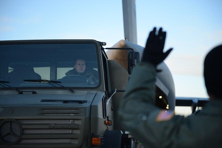 A U.S. Airman directs a French soldier and his military vehicle onto a U.S. Air Force C-17 Globemaster III cargo aircraft in Istres, France, Jan. 21, 2013.  The United States has agreed to help France airlift troops and equipment into Mali. (U.S. Air Force photo by Staff Sergeant Nathanael Callon) (Released)