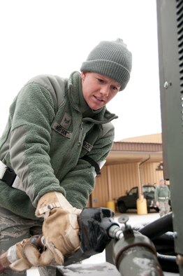 Senior Airman Rachel Marsan pumps fuel into a generator, Pease Air National Guard Base, N.H., February 3, 2013.  (National Guard photo by Staff Sgt. Curtis J. Lenz/Released)