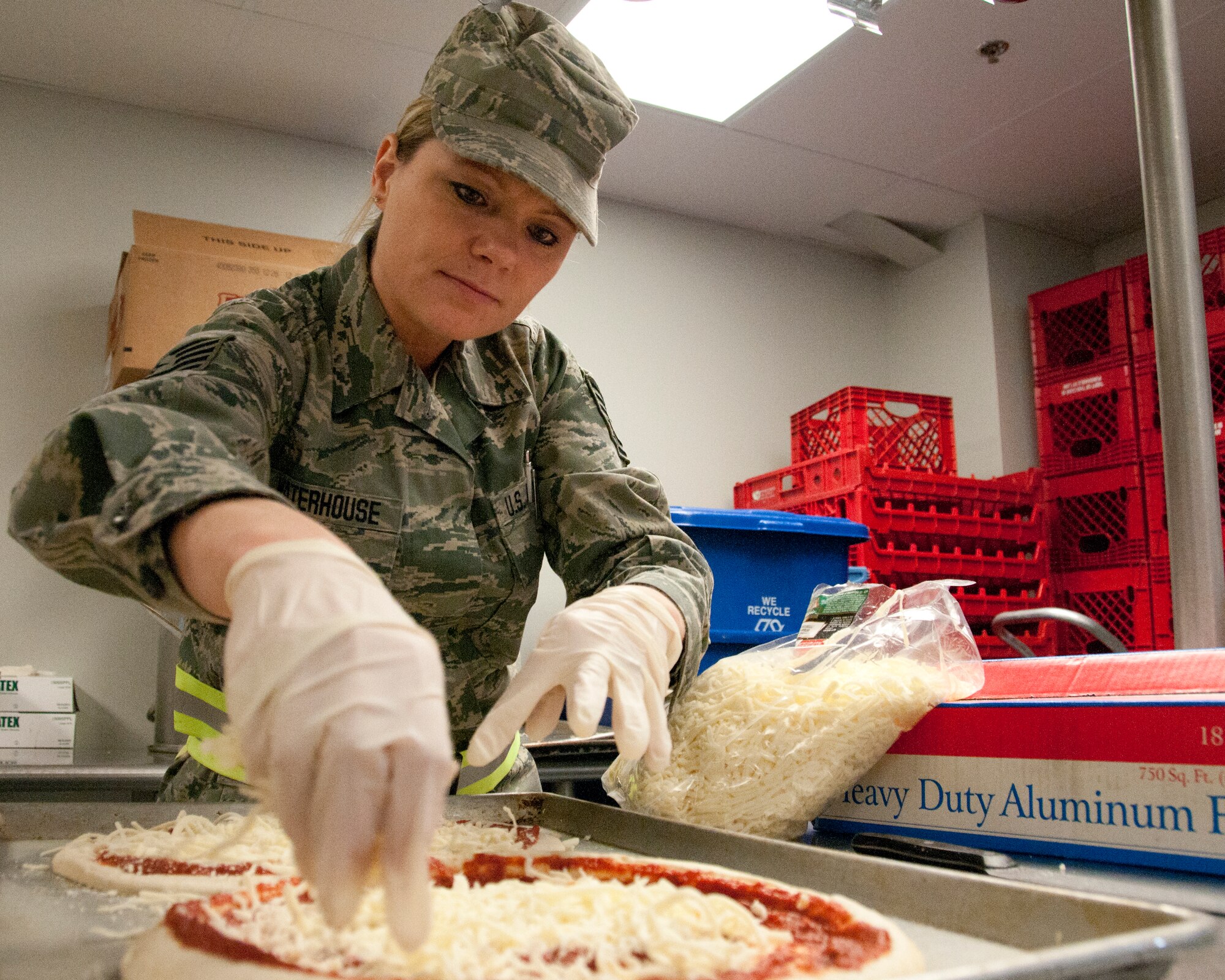 Tech. Sgt. Amy E. Waterhouse makes a pizza for afternoon meal, Pease Air National Guard Base, N.H., February 3, 2013.  (National Guard photo by Staff Sgt. Curtis J. Lenz/Released)