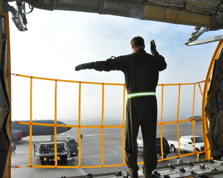 Master Sgt. Mark E. McElmurry, 77th Air Refueling Squadron, directs a K-loader as part of his required cargo "check ride" evaluation in January 2013. (USAF photo by MSgt. Wendy Lopedote, 916ARW/PA)