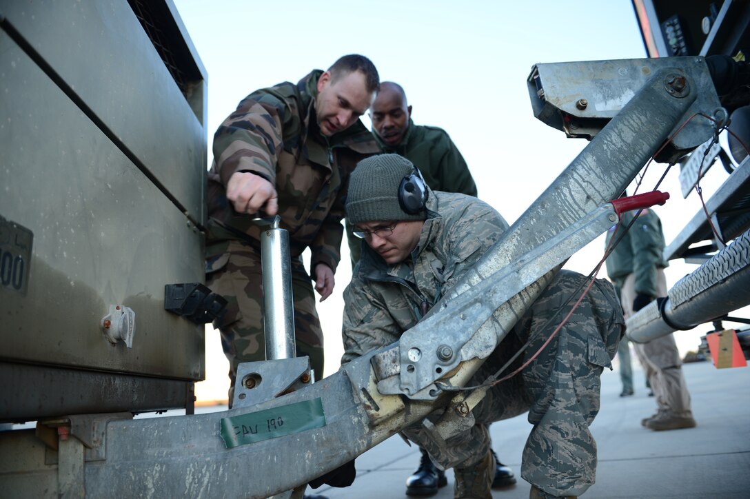 ISTRES, France – U.S. Airmen and French soldiers disconnect a power cart from a towing vehicle for loading into a U.S. Air Force C-17 Globemaster III cargo aircraft in Istres, France, Jan. 22, 2013. So far, the Air Force has transported hundreds of French soldiers and many critical pieces of military equipment for France. (U.S. Air Force photo by Staff Sgt. Nathanael Callon/Released)