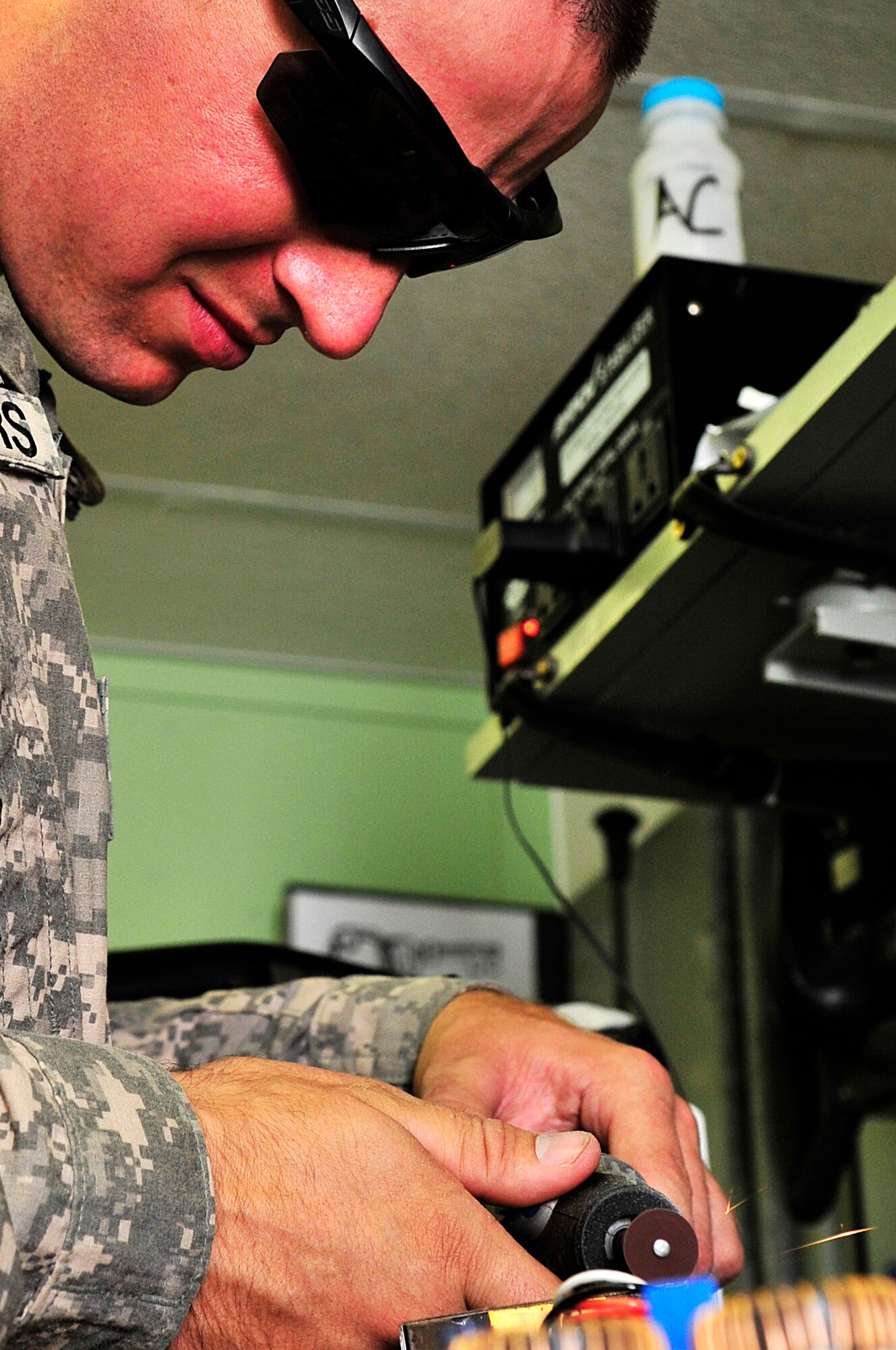 SOUTHWEST ASIA -- U.S. Army Spc. Christopher Rodgers, Headquarters and Headquarters Battery, 1st Battalion 7th Air Defense Artillery PATRIOT system repairer, fixes a public address system Jan. 31, 2013. The Soldiers who run the Army Volunteer Repair Shop have saved personnel just under $70,000 in the replacement of game systems, controllers, televisions, cell phones, power converters, and single-portion coffee makers. (U.S. Air Force photo/Tech. Sgt. Christina M. Styer)(RELEASED)