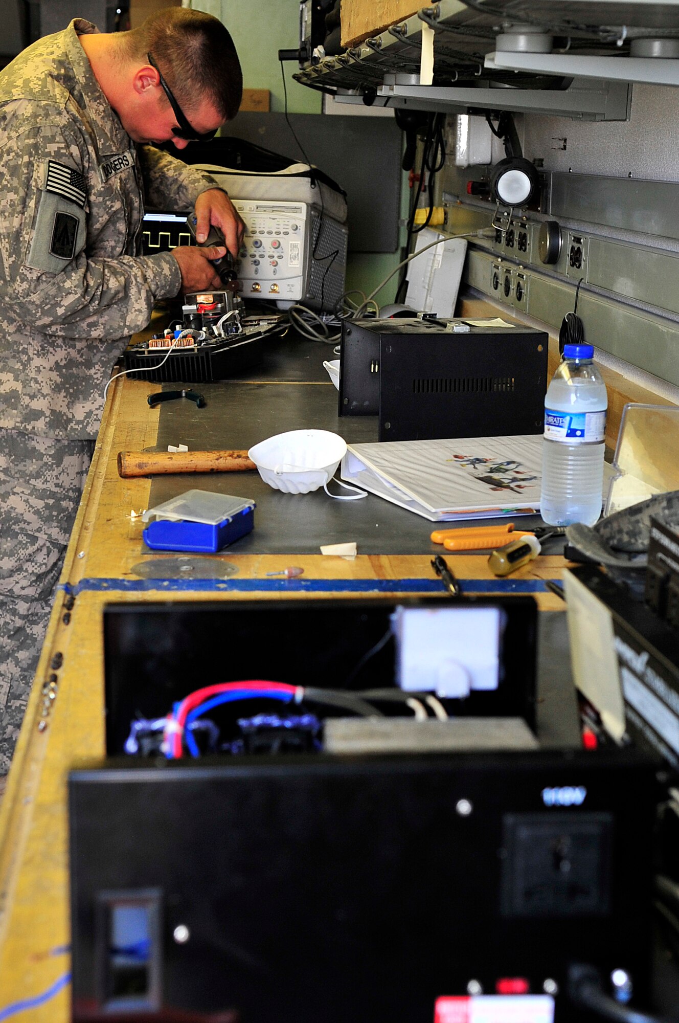 SOUTHWEST ASIA -- U.S. Army Pfc. John Howard, Headquarters and Headquarters Battery, 1st Battalion 7th Air Defense Artillery PATRIOT system repairer, fixes a public address system Jan. 31, 2013. Soldiers assigned to the 1-7 ADA are deployed to maintain the PATRIOT missile system and perfect their maintenance skills by repairing items such as game systems, controllers, televisions, cell phones, power converters, and single-portion coffee makers broken by other service members. (U.S. Air Force photo/Tech. Sgt. Christina M. Styer)(RELEASED)
