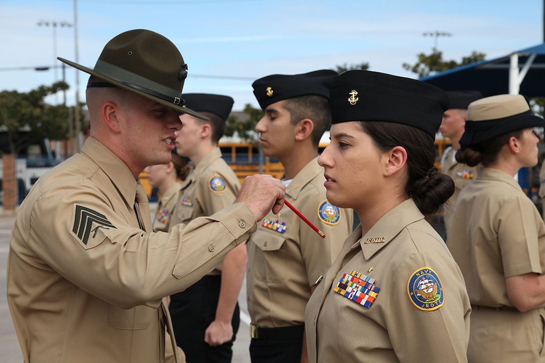 Sgt Andrews Stevens, Drill Instructor for Support Battalion, MCRD San Diego, points out a discrepancy on Cadet Maddie Silva's uniform at Coronado High School, CA on Feb 2.  The cadets from each school had to go through a rigorious uniform inspection on par with what military personnel experience as well.