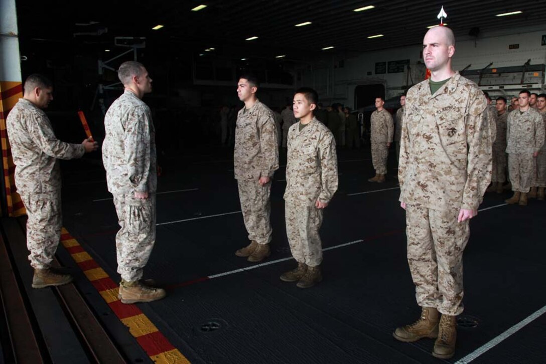 Marines with Headquarters and Service Company, Battalion Landing Team 3/5, 15th Marine Expeditionary Unit, report to Capt. Braxton H. Mashburn, their commanding officer, during a promotion ceremony held in the hangar bay of the USS Peleliu, Feb. 1. The 15th MEU is deployed as part of the Peleliu Amphibious Ready Group as a U.S. Central Command theater reserve force, providing support for maritime security operations and theater security cooperation efforts in the U.S. 5th Fleet area of responsibility. (U.S. Marine Corps photo by Cpl. John Robbart III)