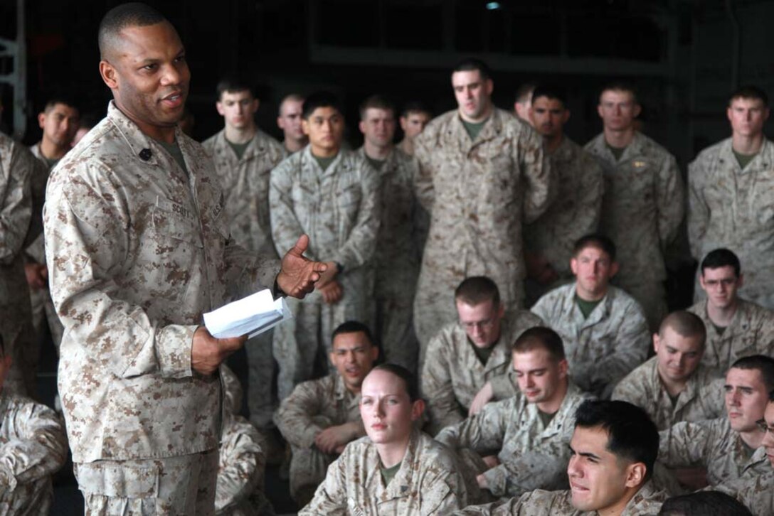 Sergeant Maj. John W. Scott, sergeant major, 15th Marine Expeditionary Unit, address his Marines and sailors after a promotion and awards ceremony held in the hangar bay of the USS Peleliu, Feb. 1. The 15th MEU is deployed as part of the Peleliu Amphibious Ready Group as a U.S. Central Command theater reserve force, providing support for maritime security operations and theater security cooperation efforts in the U.S. 5th Fleet area of responsibility. (U.S. Marine Corps photo by Cpl. John Robbart III)