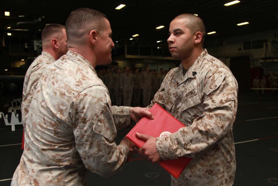 USS PELELIU (Feb. 2, 2013) Sergeant Jason M. May, data chief, Marine Medium Helicopter Squadron 364 (Rein.), 15th Marine Expeditionary Unit, receives a Certificate of Commendation from Lt. Col. Ned M. Biehl, his commanding officer, during a ceremony held in the hangar bay of the USS Peleliu, Feb. 2. May received the award for being selected as the Non-Commissioned Officer of the Year for HMM-364 (Rein.). Marine Medium Helicopter Squadron 364 (Rein.) serves as the aviation combat element for the 15th MEU. The 15th MEU is deployed as part of the Peleliu Amphibious Ready Group as a U.S. Central Command theater reserve force, providing support for maritime security operations and theater security cooperation efforts in the U.S. 5th Fleet area of responsibility. May, 32, is from Bergenfield, N.J. (U.S. Marine Corps photo by Cpl. John Robbart III) 